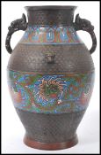 A early 20th Century oriental Chinese champleve bronze twin handled vase having enamelled panels
