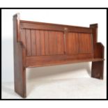 A 19th century pitch pine ecclesiastical church pew of shaped form being of small proportions. The