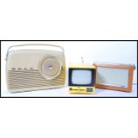 A vintage retro 20th century small portable TV television in a vibrant yellow colourway along with