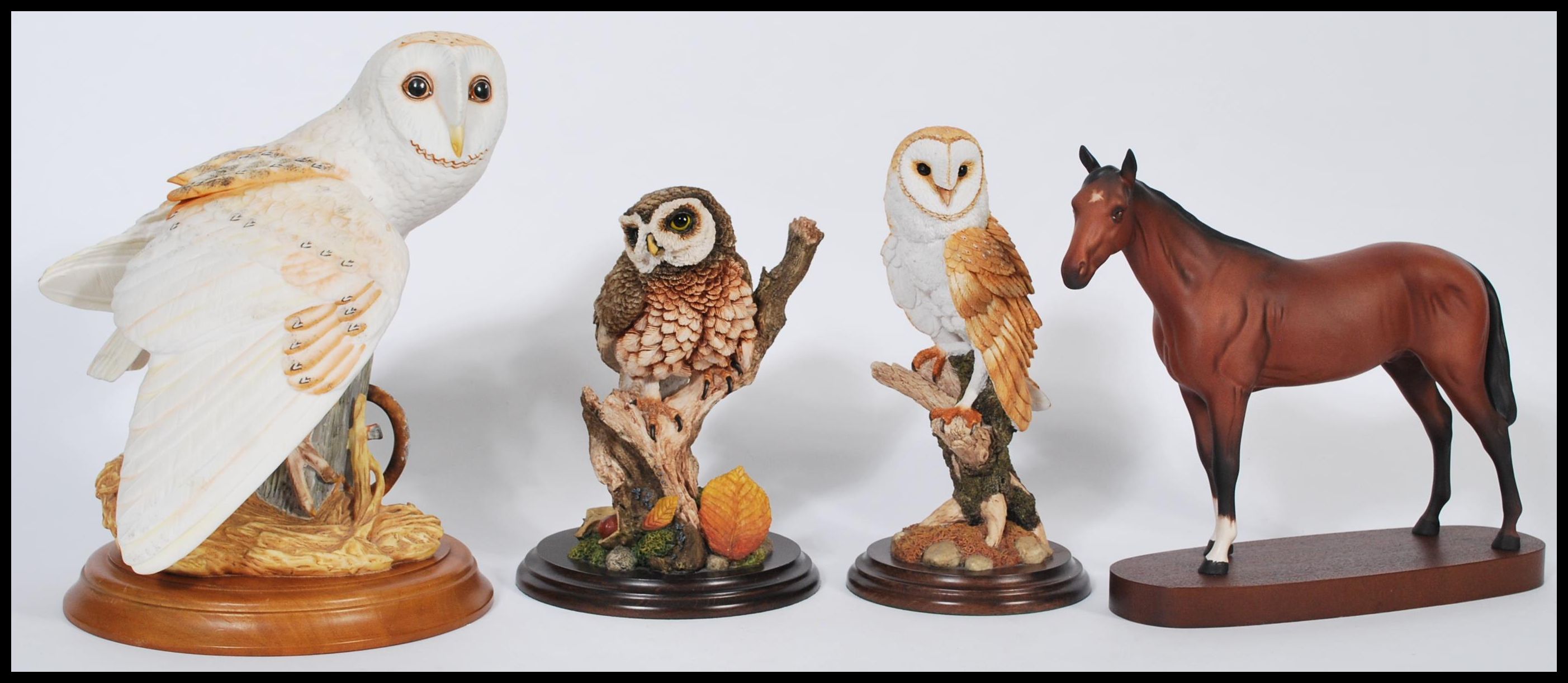 A group of ceramic and resin animals to include a Royal Doulton ceramic horse on wooden base, a