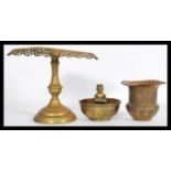 A selection of brass items to include a prayer bow