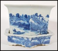An 19th century blue and white ceramic Chinese jardiniere and stand having a hexagonal shape. Hand