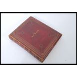 A Victorian 19th century red leather gilt tooled bound scrap album / decoupage. Containing various