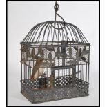 A charming vintage 20th century wire work bird cage having a domed top with hook atop. Complete with