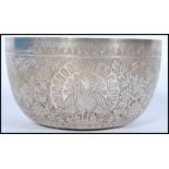 A 19th century Indian silver prayer bowl having embossed peacock and birds of paradise decoration