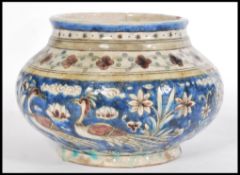 A 19th century Islamic Middle Eastern pottery Faience bowl of bulbous form having hand painted
