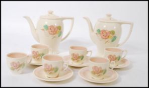 A vintage mid 20th Century Susie Cooper coffee service in a Picnic Rose pattern including two coffee