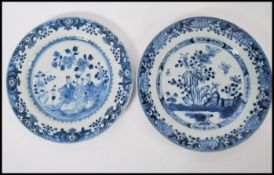 Two 18th century Chinese blue and white plates one having hand painted floral borders with central