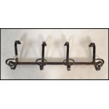 A set of vintage early 20th Century wall hanging coat hooks, each hook having a large and small hook