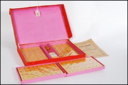 A vintage 20th century unused Mahjong Chinese game of four winds set appearing unused in case.