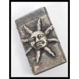 A silver plated vesta case having embossed decoration in the form of a sun. Weight 36.2g.