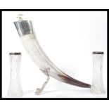 A large ox horn - claret jug having silver plated collar and lid with shaped white metal stand
