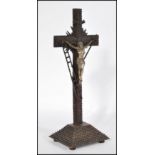 A contemporary tramp / outsider art geometric carved wood crucifix sculpture depicting the
