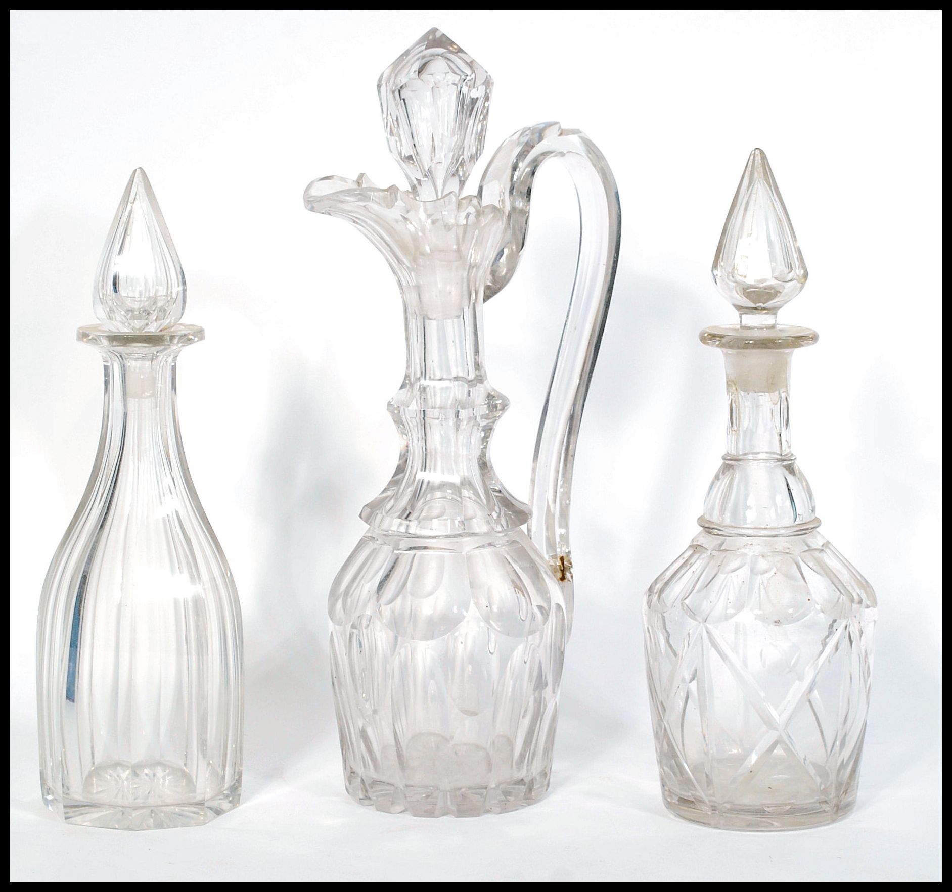 An early 19th Century English heavy cut glass Claret Jug / decanter with fitted stopper, riveted