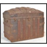 A late 19th Century dome topped metal mounted trunk chest, paper lined to the interior, with lock to
