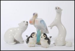 A group of vintage USSR ceramic figures to include polar bear, weasel etc. Along with other