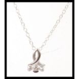 A stamped 925 silver chain necklace having a stamped 750 white gold pendant set with a brilliant cut