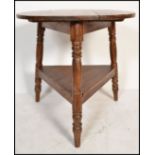 A vintage 20th Century pine tavern table, circular top raised on tripod three tuned supports