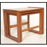 A 1970's teak wood Danish manner nest of tables. Each raised on shaped legs with returns to the