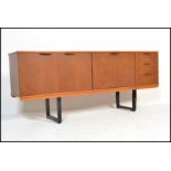 A vintage retro 20th Century teak wood sideboard / credenza, having bi - fold doors nest to fall