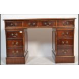 An antique Georgian style mahogany twin pedestal office desk having pedestals, each with banks of