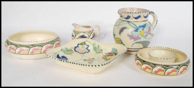 A collection of early 20th Century hand painted Honiton studio pottery, to include vase, jug, flower