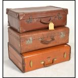 A stack of vintage suitcases / trunks to include a good leather Samsonite example and 2 early 20th