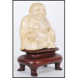 A 19th century Chinese Ivory carved Buddha. The laughing Buddha seated in the lotus position and