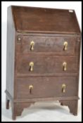 A late 19th century small country oak ladies bureau. Raised on bracket feet with upright bank of