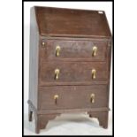 A late 19th century small country oak ladies bureau. Raised on bracket feet with upright bank of