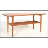 A vintage retro 20th Century Danish inspired coffee table, mahogany top raised on a teak wood frame,