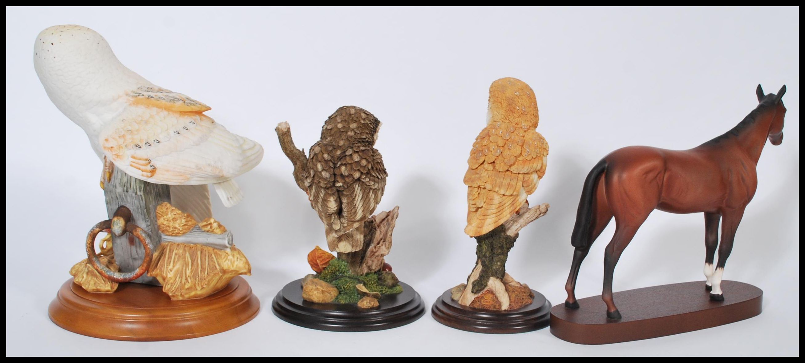 A group of ceramic and resin animals to include a Royal Doulton ceramic horse on wooden base, a - Image 2 of 5