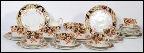A six person Imari pattern tea service consisting of six cup saucer and side plate trios, sugar