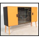 A retro 20th century painted yellow and black sideboard cabinet having two tone colourway being
