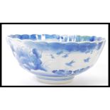A 19th century Chinese blue and white bowl of scalloped form having hand painted decoration of birds