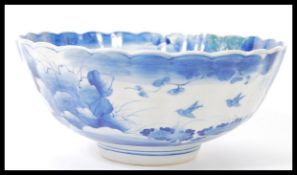 A 19th century Chinese blue and white bowl of scalloped form having hand painted decoration of birds