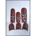 A group of 20th century graduating wooden African tribal wall masks of colourful decorative