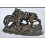 A vintage 20th century bronze effect bronzed figurine group of a lion and lioness raised on