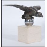 A vintage early 20th century silver plated bronze car mascot in the form of an eagle raised on