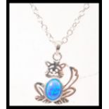 A silver pendant necklace in the form of cat set with an opal to the centre. Weight 3.4g. Chain