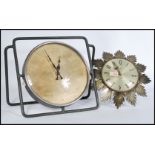 Two vintage clocks to include a Metamec sunburst wall clock and another large clock on tubular