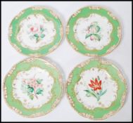 A set of four 19th Century ribbon cabinet plates having pierced green rims with gilt detailing and