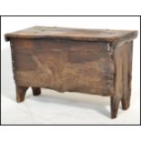 A small 17th / early 18th century country oak coffer chest of small proportions being raised on