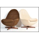 A pair of retro 20th Century swivel  egg chairs in the manner of Greaves and Thomas, one chair