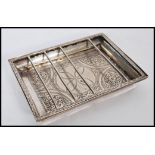 A 19th century Egyptian silver serving dish of square form having floral medallions with barred