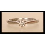 A hallmarked 18ct white gold diamond solitaire ring having a central prong set diamond with open