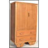 A vintage 20th Century Art Deco oak tallboy, upper doors raised over a bank of two long drawers,