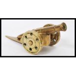 A vintage 20th century cast brass miniature Trench art type desk cannon of typical form.Measures