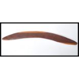 A 20th Century Australian hard carved wooden boomerang having unusual emu decoration. Measures