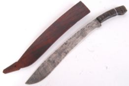 An antique 20th century wooden handled Filipino Bolas knife, within its original partially decorated